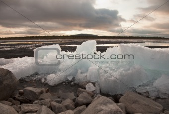 Ice thaws on bank of lake