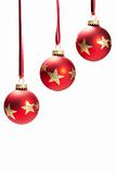 three hanging dull red christmas balls with golden stars
