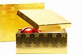 two golden present boxes with one christmas ball