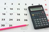 Calculator and pencil on the calendar