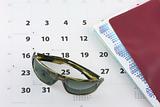 Sunglasses, tickets and calendar