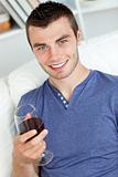 handsome young man enjoying a glass of red wine