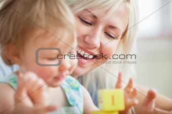Close-up of a bright mother playing with her daughter