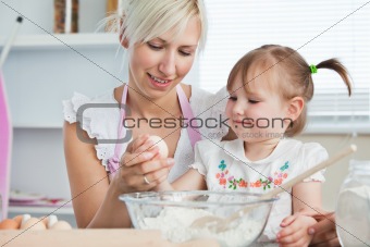 Happy mother and daughter baking together 