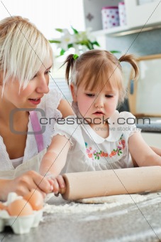 Attentive young mother baking with her daughter