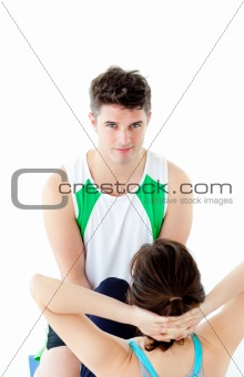 Male therapist doing fitness exercises with a woman 