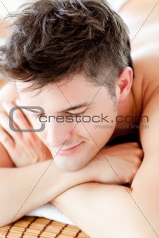 Portrait of a smiling man lying on a massage table 