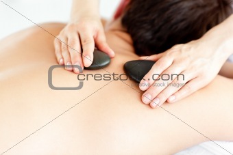 Close-up of a man with hot stone on his back 
