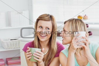 Joyful caucasian friends drinking coffee after baking 