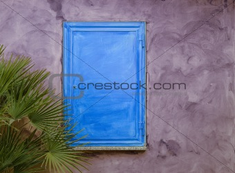 Blue wood shutter on purple wall