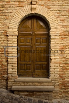 Wooden door in stone archway