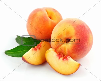 fresh peach fruits with green leaves
