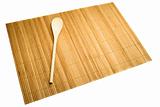 Wooden spoon on mat of bamboo