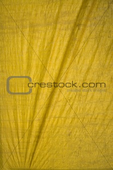 Yellow tarpaulin with folds