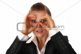 modern business woman making binoculars with hands and looking through