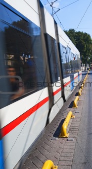 Metro train travelling down a street