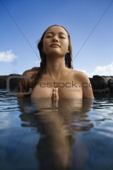 Nude woman in water.