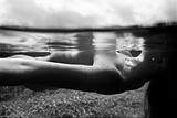 Nude woman underwater.