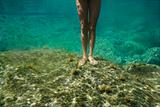 Female legs underwater.