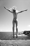 Nude woman jumping.