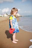 Small girl standing on beach