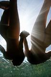 Nude women underwater.