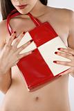 Woman covering breast with purse.