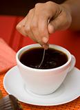 Stirring black coffee