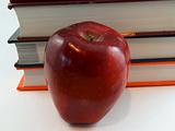 Apple in front of book