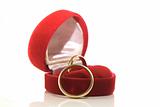 Gold wedding rings in red box isolated on white