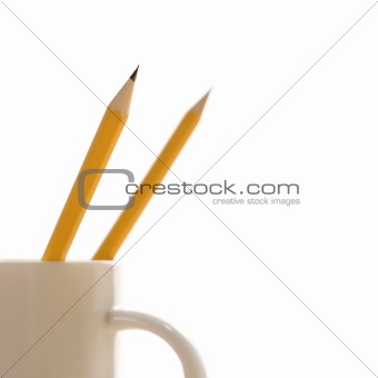 Pencils in coffee cup.