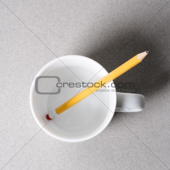 Pencil in coffee cup.
