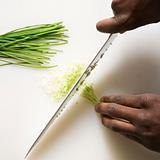 Knife chopping chives.