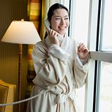 Woman in bathrobe on phone.