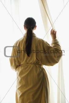 Woman looking out window.