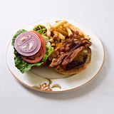 Bacon cheeseburger on plate.