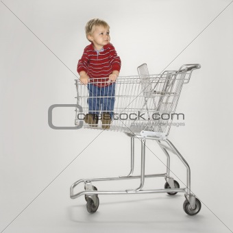 Boy in empty cart.