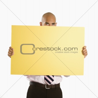 Businessman holding blank sign.
