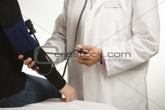Doctor testing blood pressure.
