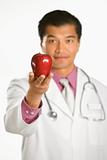Doctor holding apple.