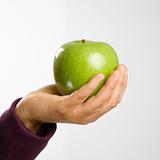 Hand holding apple.