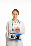 Doctor holding open sign.