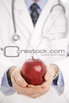 Doctor holding apple.