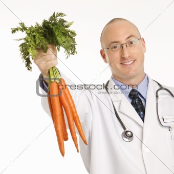 Doctor holding carrots.