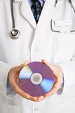 Doctor holding compact disc.