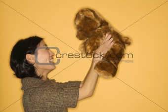 Woman holding teddy bear.
