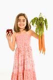 Girl holding vegetables.