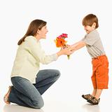 Son giving mother flowers.