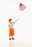 Boy holding American flag.