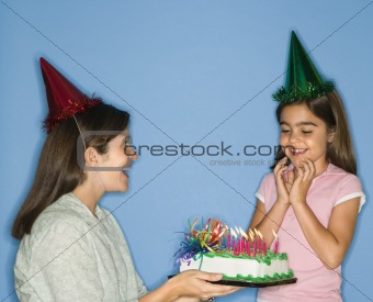 Girl getting birthday cake.
